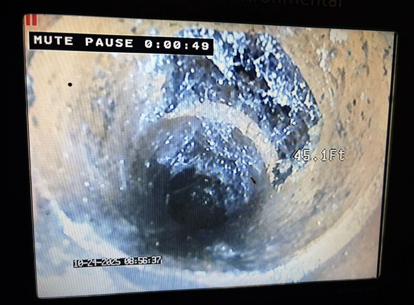 Sewer camera inspection showing buildup and damage inside sewer pipe