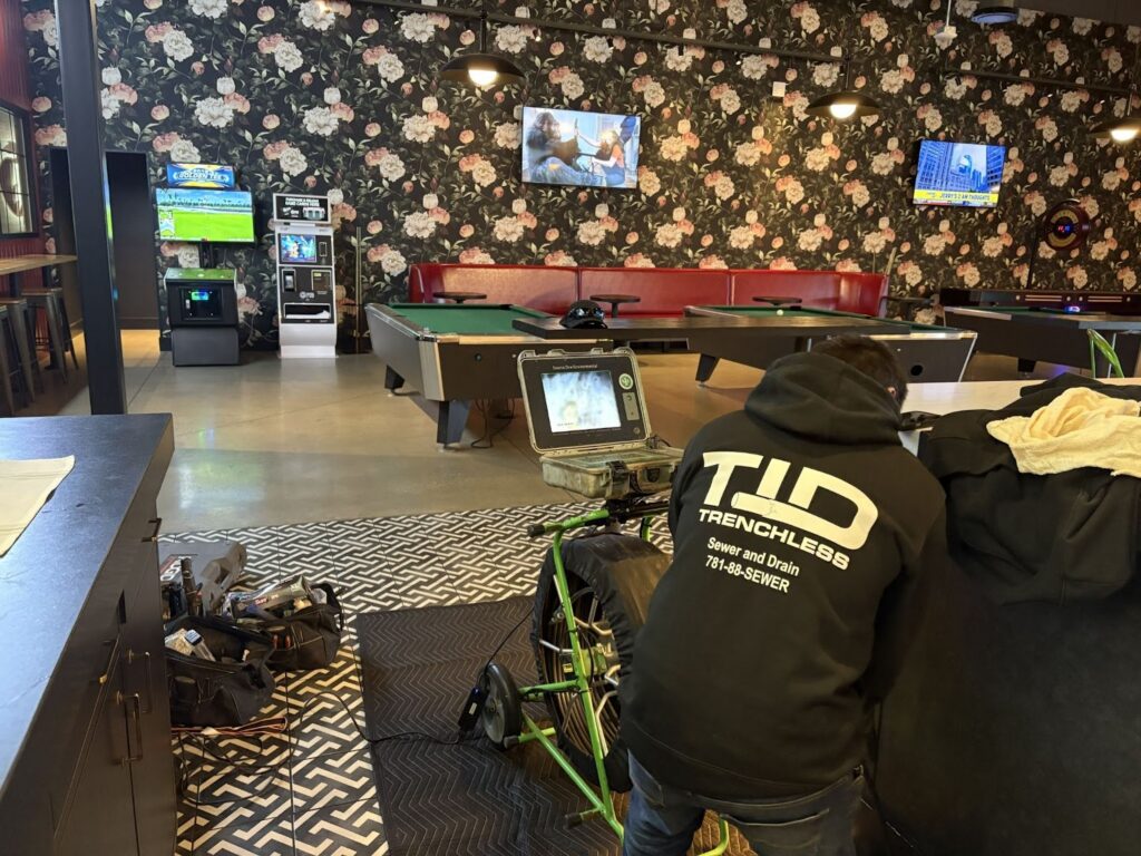 Technician performing a sewer camera inspection during commercial drain cleaning service