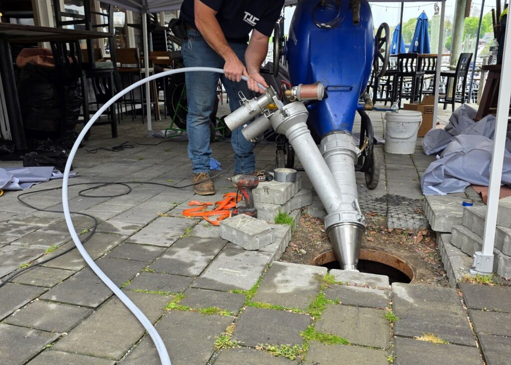 Technician performing professional drain cleaning using specialized equipment