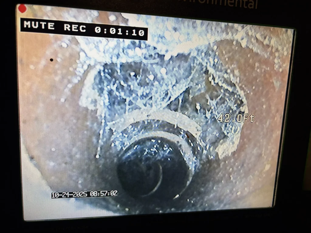 Sewer camera inspection footage showing severe pipe corrosion and scale buildup at 42 feet inside a residential sewer line in Massachusetts