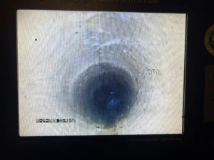 Sewer camera inspection footage showing pipe interior deterioration and buildup inside a residential sewer line