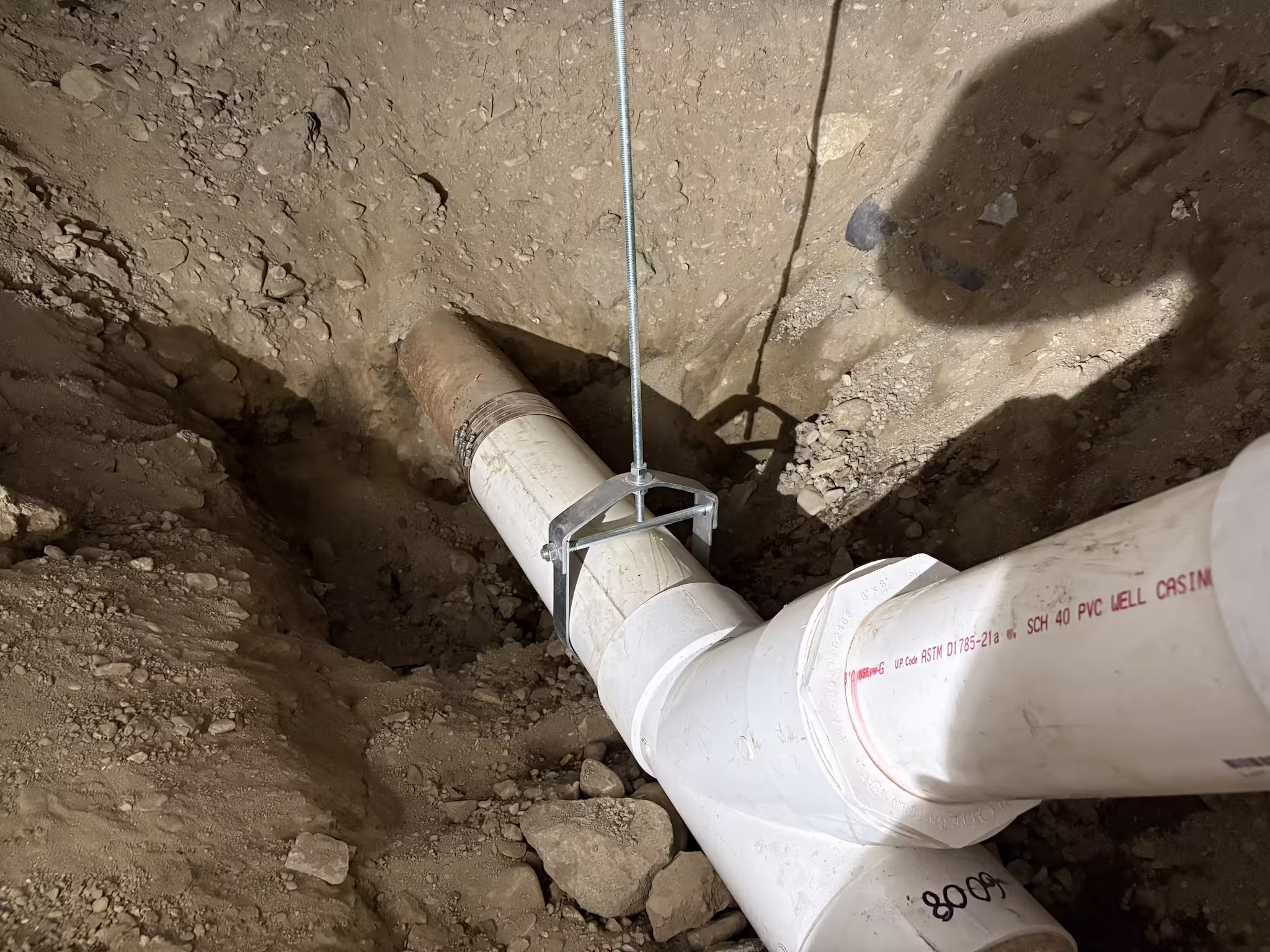 TID Trenchless sewer line replacement showing a new PVC pipe connecting to an existing line in Massachusetts 