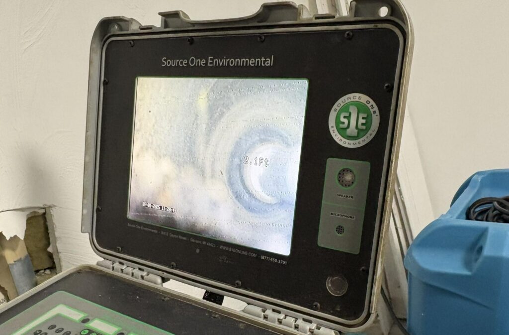 Sewer camera monitor showing the inside of a drain line during a TID Trenchless inspection.