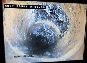 Sewer camera footage showing buildup inside a main sewer line during a Massachusetts inspection