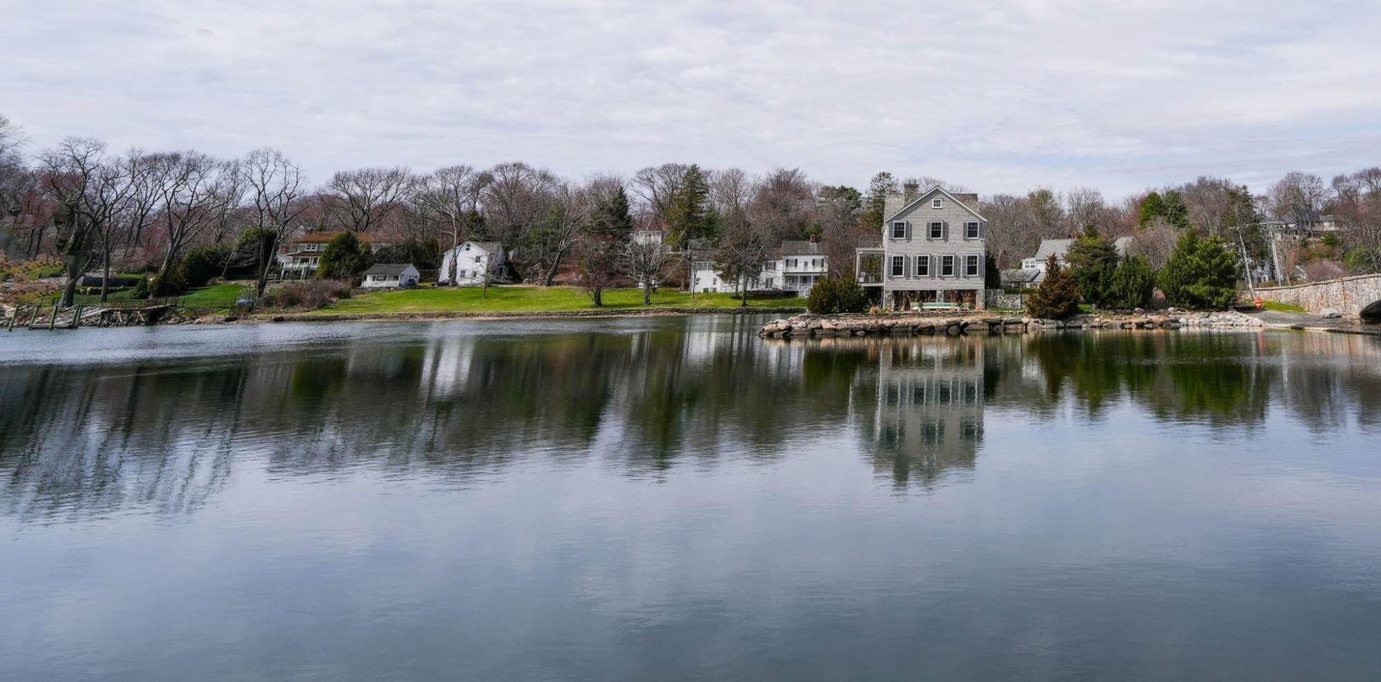 Riverfront single-family homes in Dedham, MA, part of the TID Trenchless drain cleaning service area.