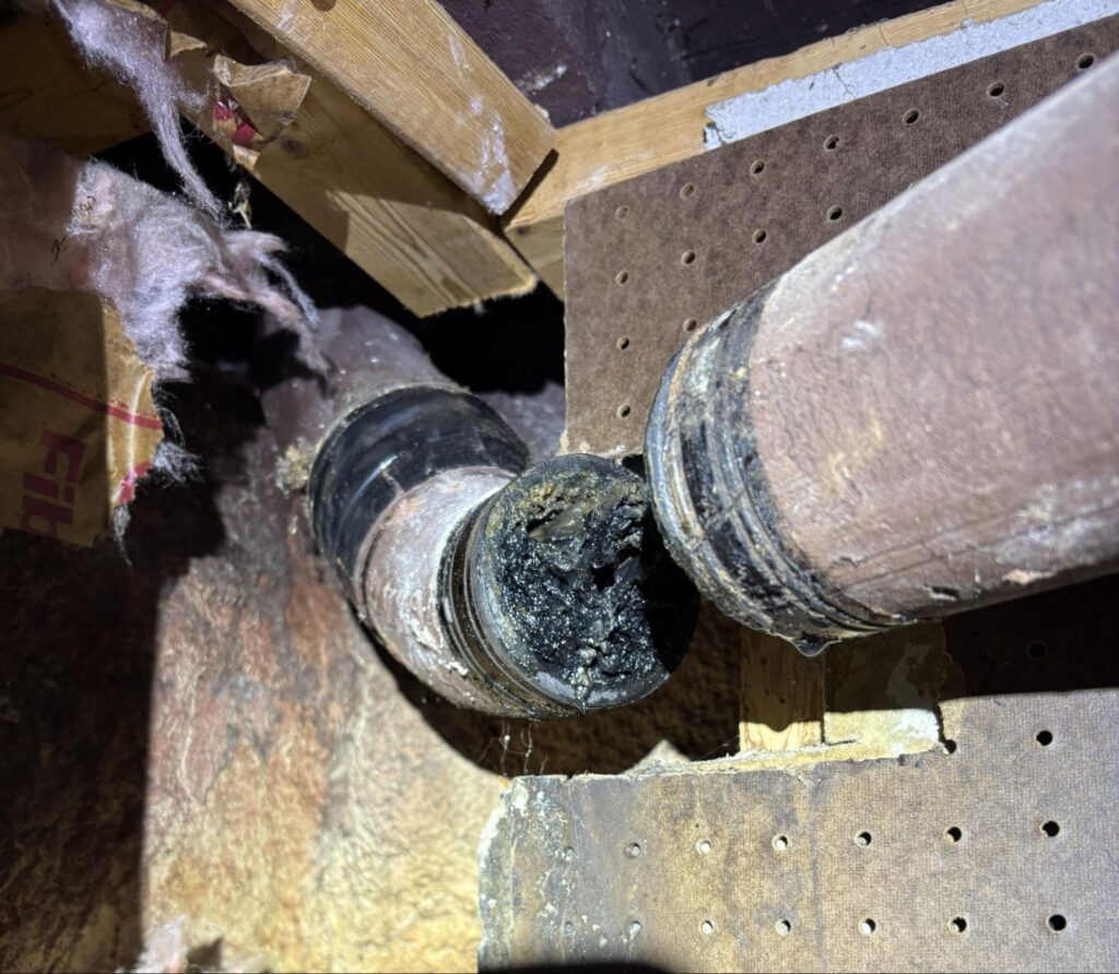 Corroded cast iron drain pipe packed with scale before epoxy pipe restoration