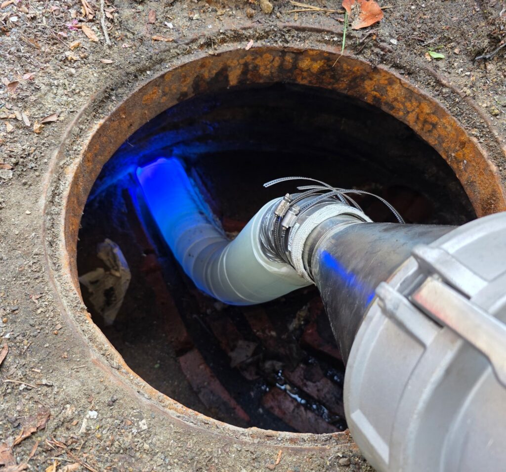 UV light curing a new CIPP sewer liner at an access point in Cambridge, MA.