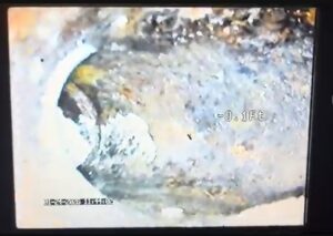 Inside a corroded sewer pipe with heavy scale, a common sewer problem in older homes