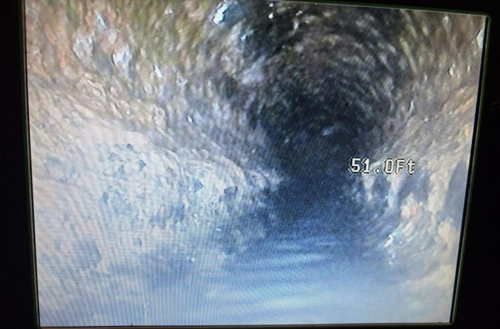 Sewer camera footage showing scale buildup inside a cast iron sewer line at 51 feet